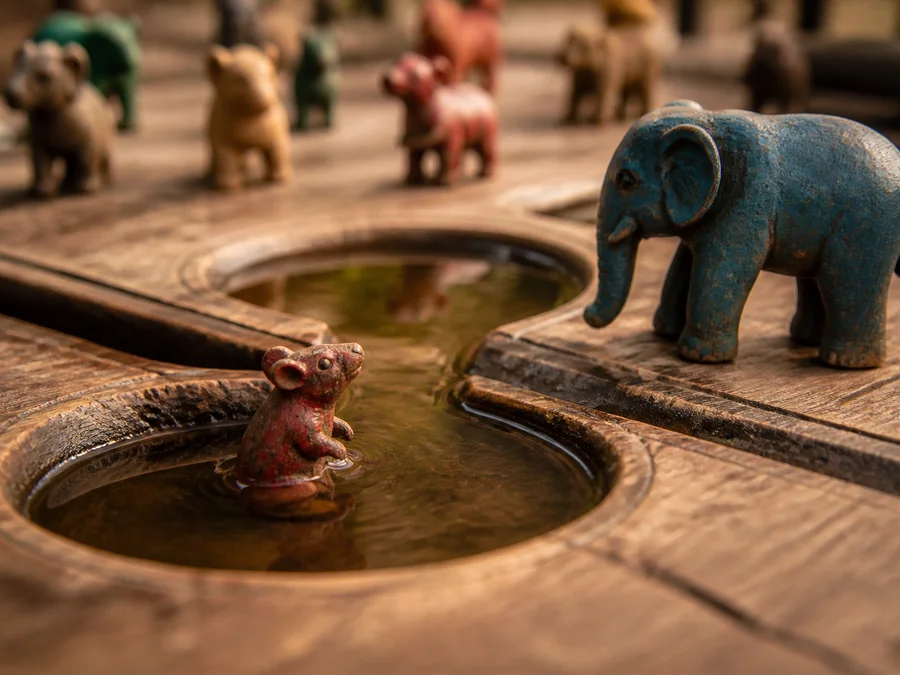 A Jungle Chess rat in the river and an elephant on the bank, showing the rat-and-elephant exception